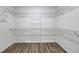 Walk-in closet featuring wire shelving, wood-look flooring, and bright overhead lighting at 1055 Laconic Dr., Myrtle Beach, SC 29588
