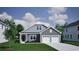 Charming gray home with a two-car garage, inviting entrance, and manicured lawn at 1055 Laconic Dr., Myrtle Beach, SC 29588