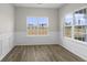 Bright living room with large windows and wood-look flooring features modern trim and neutral paint at 1055 Laconic Dr., Myrtle Beach, SC 29588