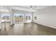 Open-concept living room with wood-look floors, a ceiling fan, and patio door leading to backyard at 1055 Laconic Dr., Myrtle Beach, SC 29588