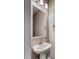Powder room with pedestal sink, brushed nickel faucet and framed mirror, and overhead lighting at 1055 Laconic Dr., Myrtle Beach, SC 29588