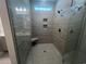 Walk-in shower features grey tiled walls, corner seat, a shower head, and a glass door at 1055 Laconic Dr., Myrtle Beach, SC 29588