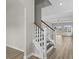 Open-concept staircase leading to a living space with natural light and hardwood floors at 1055 Laconic Dr., Myrtle Beach, SC 29588