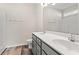 Bathroom featuring double sink vanity, a full mirror, wood look flooring, and tub shower at 109 Old Chimney Ln, Conway, SC 29526
