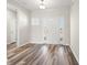 Bright foyer featuring hardwood floors and a white door with glass sidelights and transom at 109 Old Chimney Ln, Conway, SC 29526