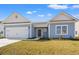 Charming single-story home with a light blue exterior, white trim, and a two-car garage at 109 Old Chimney Ln, Conway, SC 29526