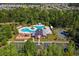 Aerial view features a pool, barn, playground, basketball court, and parking in a serene community setting at 1127 Harvester Circle # 1127, Myrtle Beach, SC 29579