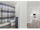 Bathroom and hallway featuring tile floors, a tiled shower with curtain, dark vanity, and stairway at 1127 Harvester Circle # 1127, Myrtle Beach, SC 29579