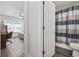View of a bedroom and bathroom featuring hardwood floors, a bed, desk, and tiled shower with curtain at 1127 Harvester Circle # 1127, Myrtle Beach, SC 29579