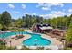 A uniquely designed swimming pool and barn-like recreation center are surrounded by mature trees at 1127 Harvester Circle # 1127, Myrtle Beach, SC 29579