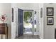 View of the home's foyer, featuring wood flooring, artwork and an open front door at 1127 Harvester Circle # 1127, Myrtle Beach, SC 29579