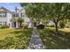 Charming two-story townhome with blue shutters and a well-manicured lawn and walkway at 1127 Harvester Circle # 1127, Myrtle Beach, SC 29579