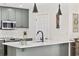 Kitchen area with shaker cabinets, white backsplash, and decorative pendant lights at 1127 Harvester Circle # 1127, Myrtle Beach, SC 29579