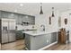 Open kitchen features a center island, stainless appliances, and gray-green cabinets at 1127 Harvester Circle # 1127, Myrtle Beach, SC 29579