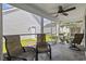 Screened porch furnished with seating, fan, and a view of the yard at 1127 Harvester Circle # 1127, Myrtle Beach, SC 29579