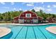 A clear swimming pool in front of the barn-style building adds charm to the community amenities at 1127 Harvester Circle # 1127, Myrtle Beach, SC 29579