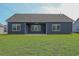 Rear exterior view of home featuring a covered patio and a well-maintained lawn at 115 Old Chimney Ln, Conway, SC 29526