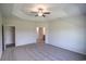 Bright bedroom showcasing tray ceiling, a ceiling fan, and ensuite bathroom access at 115 Old Chimney Ln, Conway, SC 29526