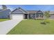 Charming single-story home with a well-manicured lawn, brick accents, and a two-car garage at 115 Old Chimney Ln, Conway, SC 29526
