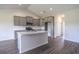 Well-lit kitchen boasts stainless appliances, grey cabinets, and a functional kitchen island at 115 Old Chimney Ln, Conway, SC 29526