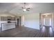 Open floor plan featuring spacious living area with wood floors, leading into the kitchen at 115 Old Chimney Ln, Conway, SC 29526