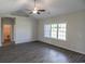 Spacious living room with vinyl plank flooring, ceiling fan, and large window at 115 Old Chimney Ln, Conway, SC 29526