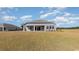 Rear exterior view shows a well-maintained lawn and covered patio area at 1224 Barrington Way, Conway, SC 29526