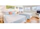 Cozy bedroom featuring two beds, bright windows, and beach-themed decor at 124 Spartina Ct. # 30, Pawleys Island, SC 29585