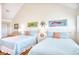 Bright bedroom with two beds, beach-themed decor, and ample natural light at 124 Spartina Ct. # 30, Pawleys Island, SC 29585