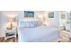 Bright bedroom featuring a comfy bed, bedside table with lamps, and adjacent bathroom at 124 Spartina Ct. # 30, Pawleys Island, SC 29585