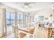 Dining area with large windows overlooking the water and a wooden dining table set for six at 124 Spartina Ct. # 30, Pawleys Island, SC 29585