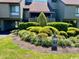 Landscaped community entrance with lush green bushes and a view of the stilt-supported homes at 124 Spartina Ct. # 30, Pawleys Island, SC 29585