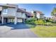 Beautiful exterior view of a multi-level home with a covered parking area and lush landscaping at 124 Spartina Ct. # 30, Pawleys Island, SC 29585