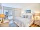 Comfortable main bedroom with white bedding, wood floors, and ample closet space at 124 Spartina Ct. # 30, Pawleys Island, SC 29585
