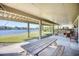 Inviting covered outdoor patio featuring a wooden picnic table and comfortable seating with water view at 124 Spartina Ct. # 30, Pawleys Island, SC 29585