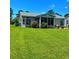 Landscaped backyard showing a screened-in porch and well-maintained lawn at 133 Lakeside Crossing Dr., Conway, SC 29526