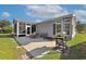 Backyard patio area with an outdoor grill, seating, screened-in porch and green grass at 133 Lakeside Crossing Dr., Conway, SC 29526