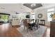 Elegant dining room with a large table, stylish chandelier, and open view of the living room at 133 Lakeside Crossing Dr., Conway, SC 29526