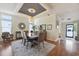 Bright dining room with a stylish tray ceiling, elegant decor, and an open layout at 133 Lakeside Crossing Dr., Conway, SC 29526