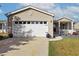 Spacious two-car garage with a concrete driveway and well-manicured lawn at 133 Lakeside Crossing Dr., Conway, SC 29526