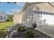 Side view of a two-car garage with vinyl siding and well-maintained landscaping at 133 Lakeside Crossing Dr., Conway, SC 29526