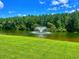 Scenic pond view with fountain and lush green landscape, perfect for relaxation and enjoying nature at 133 Lakeside Crossing Dr., Conway, SC 29526