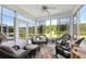 Bright sunroom with wicker furniture, views of the serene outdoors and fountain at 133 Lakeside Crossing Dr., Conway, SC 29526