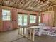 View of the unfinished living room interior featuring the insulation and door framing leading to the backyard at 133 Thrush Ct., Georgetown, SC 29440