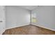 Bright, empty bedroom with wood-look flooring and a window with views at 1368 Palm Springs Paloma Dr, Longs, SC 29568