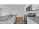 Modern kitchen with granite countertops, stainless appliances, and sleek white cabinets at 1368 Palm Springs Paloma Dr, Longs, SC 29568