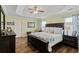 Spacious bedroom with a tray ceiling, wood furniture, and a serene atmosphere at 1439 Brighton Ave., Myrtle Beach, SC 29588