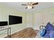 Bright bedroom featuring stylish furnishings, hardwood floors, a ceiling fan, and a window at 1439 Brighton Ave., Myrtle Beach, SC 29588