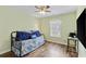 This bedroom features stylish furnishings, hardwood floors, a ceiling fan, and a window at 1439 Brighton Ave., Myrtle Beach, SC 29588