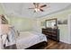 Bright bedroom features neutral walls, wood furniture, and a tray ceiling at 1439 Brighton Ave., Myrtle Beach, SC 29588
